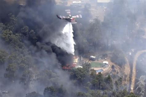 A wildfire in Australia on the outskirts of Perth destroys at least 2 homes and injures 2 people